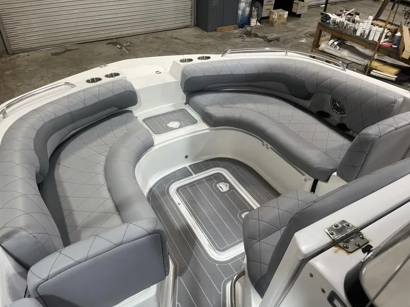 Slide: The Image of 2017 Hurricane 19 CC boat interior with gray cushioned seating and storage compartments. - 13