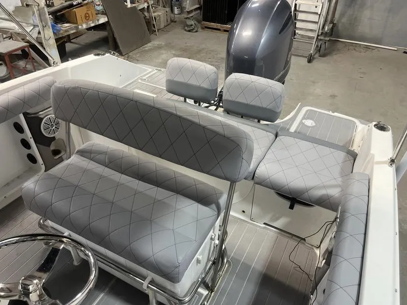Slide: The Image of 2017 Hurricane 19 CC boat interior with gray cushioned seating and steering wheel. - 4