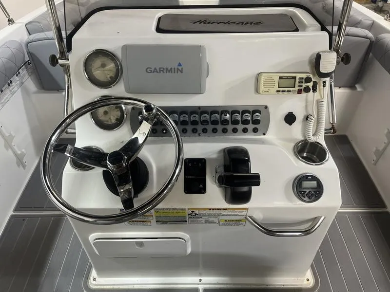 Slide: The Image of 2017 Hurricane 19 CC boat console with Garmin GPS, steering wheel, and control panel. - 7