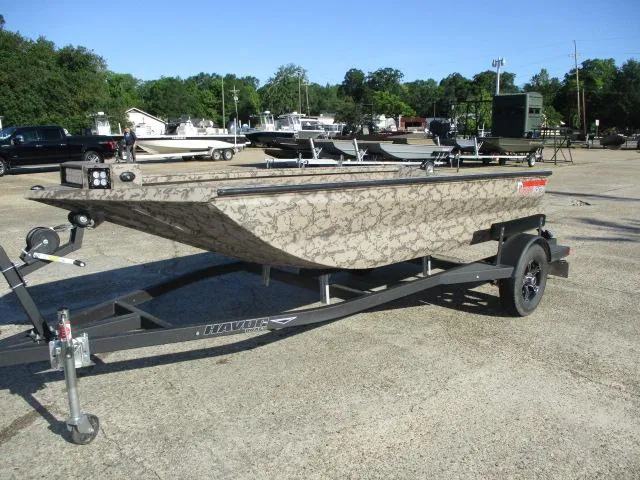 Slide: The Image of 2025 Reaper Boats 553-1426 on trailer, camouflage design, parked outdoors. - 2