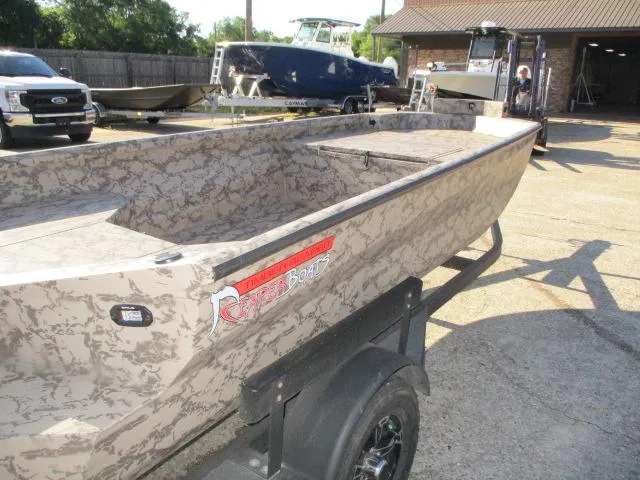 Slide: The Image of 2025 Reaper Boats 553-1426 model, camo design, parked on trailer in sunny lot. - 3