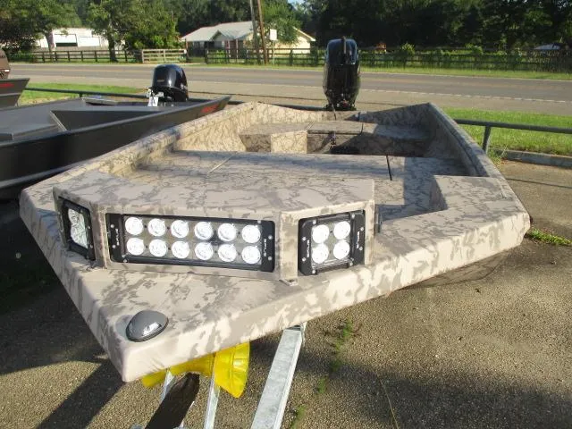 Slide: The Image of 2025 Reaper Boats 553-1426 with camouflage design and LED lights on a trailer. - 5