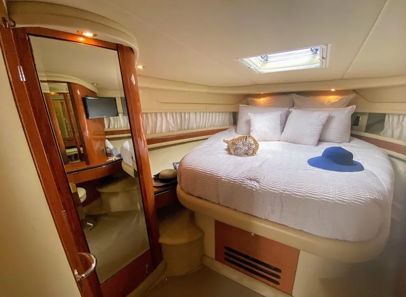 Slide: The Image of Luxurious cabin interior of 2001 Sea Ray 460 Sundancer yacht with cozy bed and decor. - 10