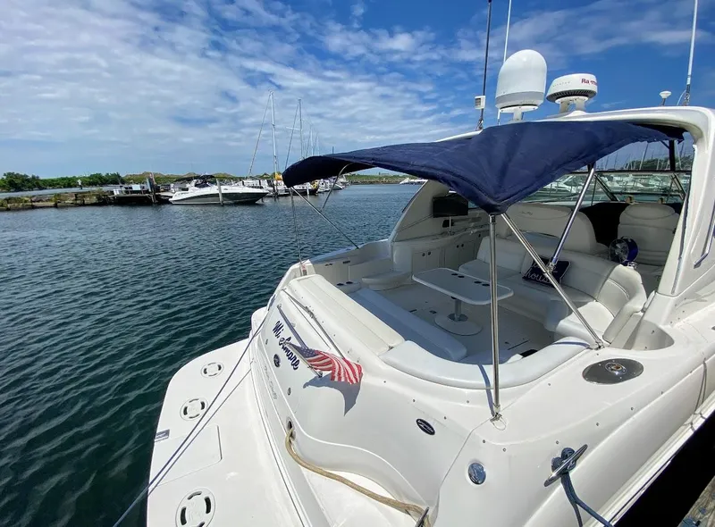 Slide: The Image of 2001 Sea Ray 460 Sundancer yacht docked at marina under blue sky. - 17