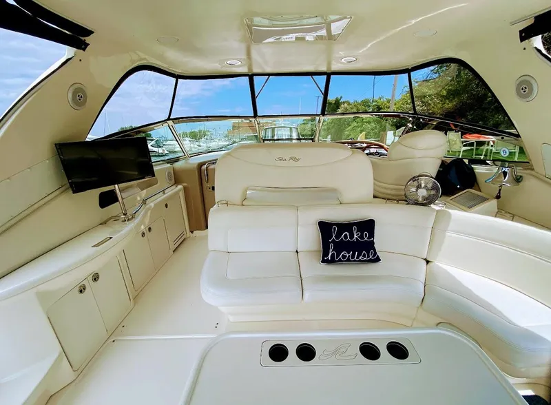 Slide: The Image of Luxurious interior of 2001 Sea Ray 460 Sundancer yacht with plush seating and "lake house" pillow. - 2