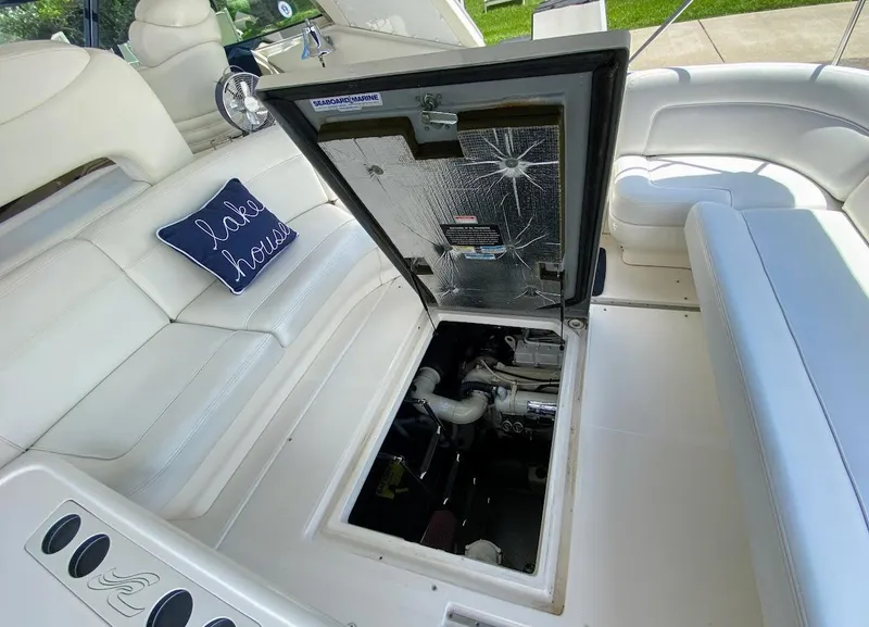 Slide: The Image of 2001 Sea Ray 460 Sundancer engine compartment open, showcasing interior details and seating area. - 22