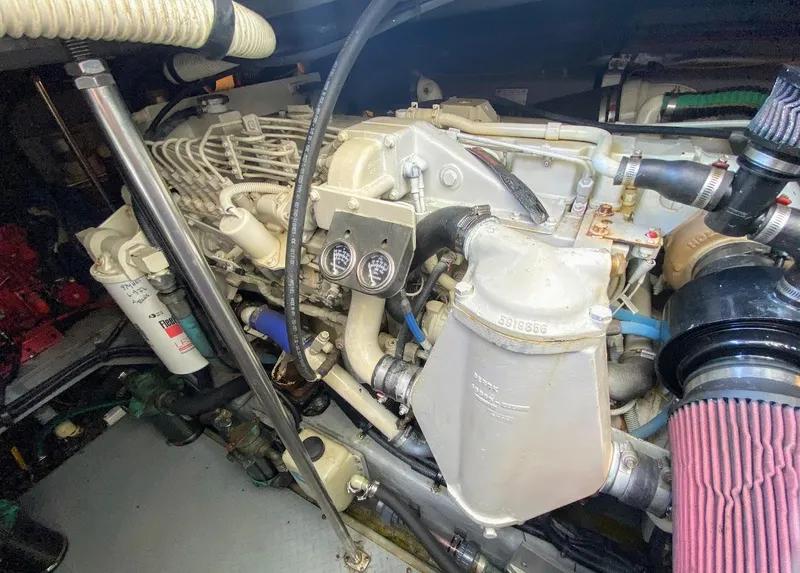 Slide: The Image of Engine compartment of a 2001 Sea Ray 460 Sundancer boat, showcasing mechanical components. - 23
