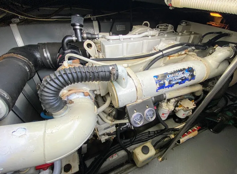 Slide: The Image of Engine compartment of a 2001 Sea Ray 460 Sundancer boat, showcasing mechanical components. - 24