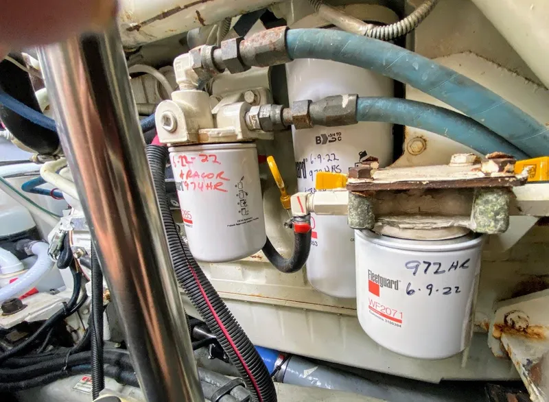 Slide: The Image of Engine compartment of a 2001 Sea Ray 460 Sundancer with visible fuel filters and hoses. - 26