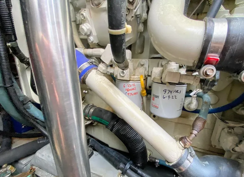 Slide: The Image of Engine compartment of a 2001 Sea Ray 460 Sundancer with visible hoses and components. - 27