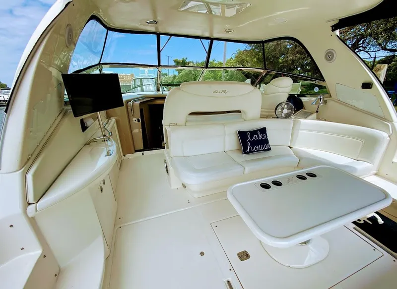 Slide: The Image of 2001 Sea Ray 460 Sundancer interior with white seating, table, and "lake house" pillow. - 29