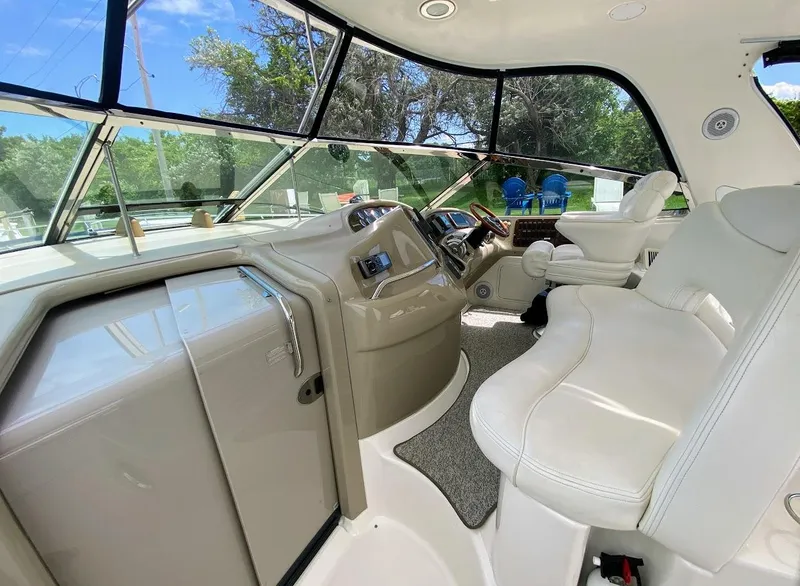 Slide: The Image of 2001 Sea Ray 460 Sundancer cockpit with white seating and modern controls. - 31