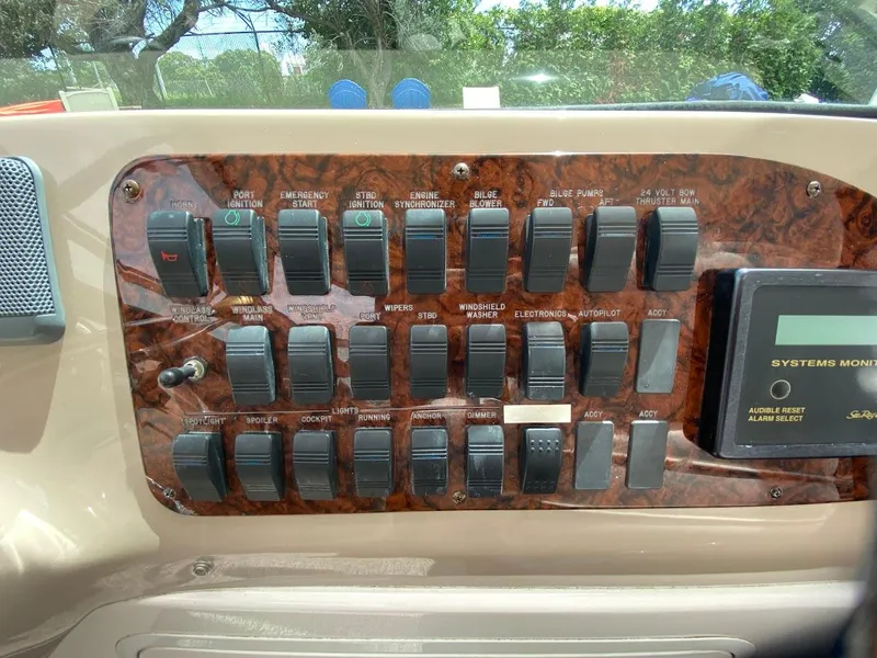 Slide: The Image of Control panel of a 2001 Sea Ray 460 Sundancer boat with labeled switches. - 32