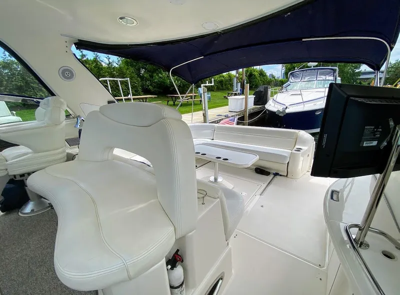 Slide: The Image of Interior of 2001 Sea Ray 460 Sundancer yacht with white seating and blue canopy. - 34