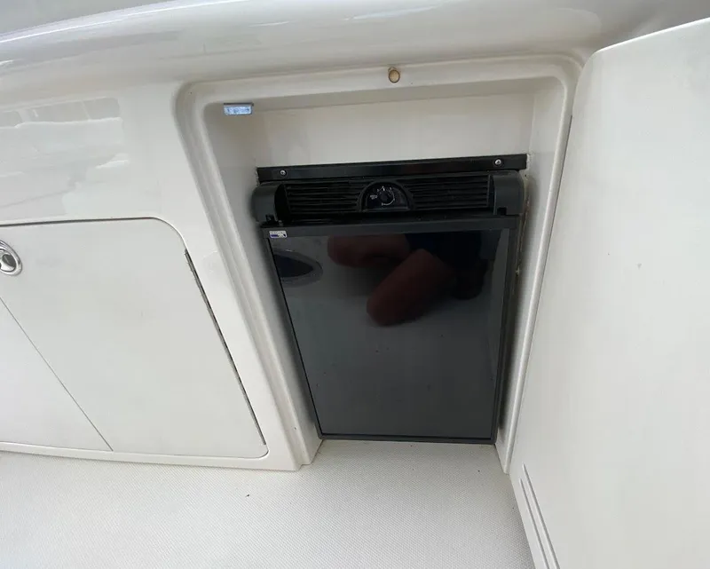 Slide: The Image of Mini fridge on 2001 Sea Ray 460 Sundancer yacht, integrated into white cabinetry. - 35
