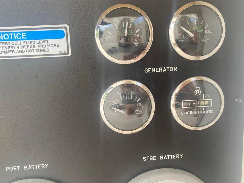 Slide: The Image of Instrument panel of a 2001 Sea Ray 460 Sundancer with gauges and battery indicators. - 37