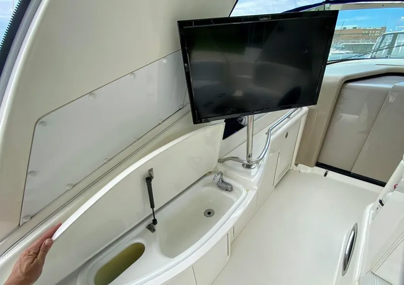 Slide: The Image of 2001 Sea Ray 460 Sundancer interior with sink and mounted TV. - 38