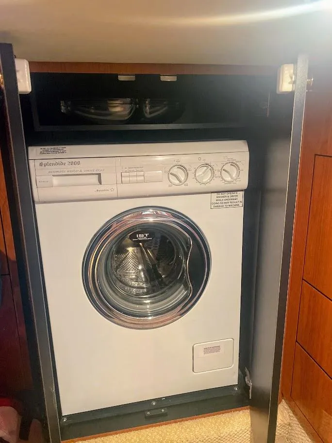 Slide: The Image of Washing machine inside 2001 Sea Ray 460 Sundancer yacht, compact and efficient design. - 40