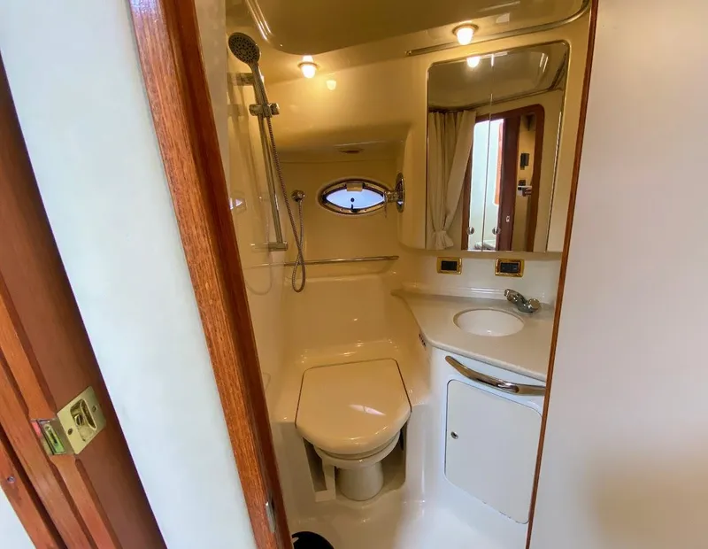 Slide: The Image of Bathroom interior of 2001 Sea Ray 460 Sundancer yacht, featuring shower, toilet, and sink. - 41