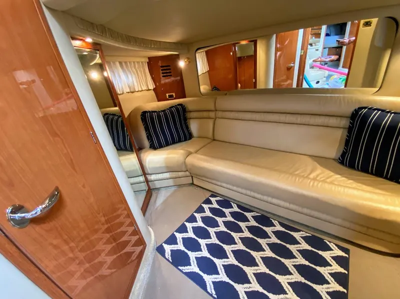 Slide: The Image of Luxurious interior of 2001 Sea Ray 460 Sundancer yacht with beige seating and navy accents. - 5