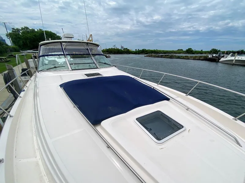 Slide: The Image of 2001 Sea Ray 460 Sundancer yacht on calm water under cloudy sky. - 6