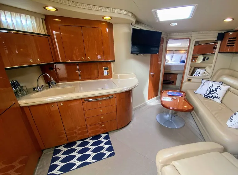 Slide: The Image of Luxurious interior of 2001 Sea Ray 460 Sundancer yacht with kitchen and seating area. - 7
