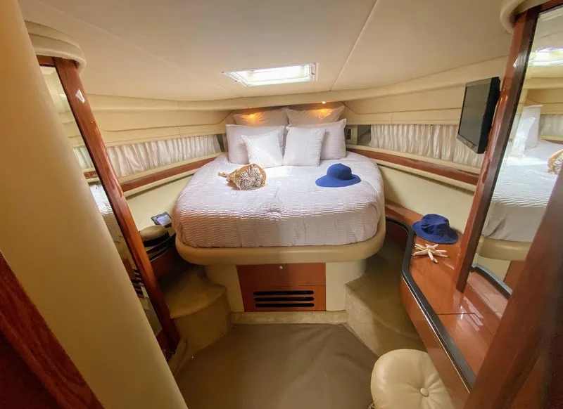 Slide: The Image of Luxurious cabin interior of 2001 Sea Ray 460 Sundancer yacht with cozy bed and elegant decor. - 8