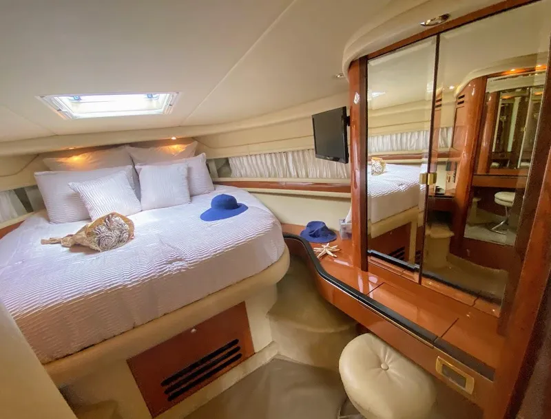 Slide: The Image of Luxurious cabin interior of 2001 Sea Ray 460 Sundancer yacht with bed and vanity. - 9