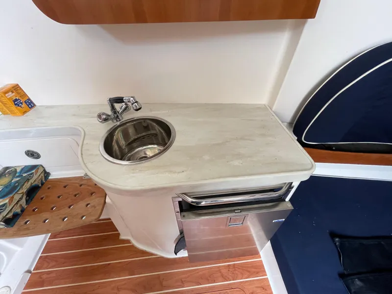 Slide: The Image of 2018 Grady-White Canyon 376 boat interior with sink, countertop, and seating area. - 13
