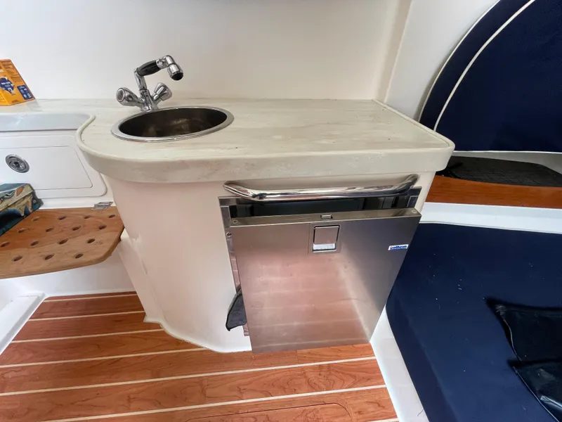 Slide: The Image of 2018 Grady-White Canyon 376 boat interior with sink, countertop, and stainless steel appliance. - 14