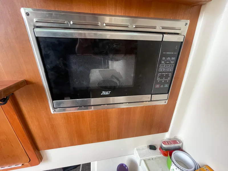 Slide: The Image of Built-in microwave in 2018 Grady-White Canyon 376 boat kitchen area. - 17