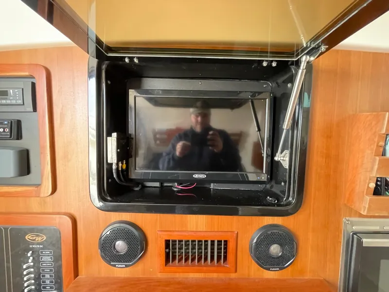 Slide: The Image of 2018 Grady-White Canyon 376 dashboard with screen, speakers, and control panel. - 20