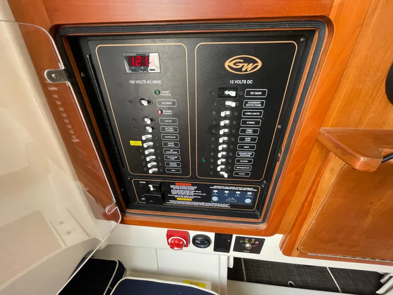 Slide: The Image of Electrical control panel on a 2018 Grady-White Canyon 376 boat, featuring various switches and indicators. - 22