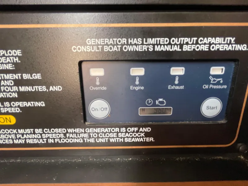 Slide: The Image of Control panel of a 2018 Grady-White Canyon 376 boat generator with warning instructions. - 25