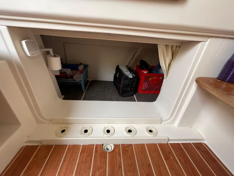 Slide: The Image of 2018 Grady-White Canyon 376 storage area with wooden flooring and organized compartments. - 26