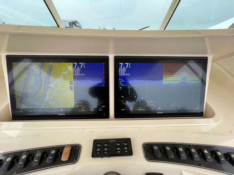 Slide: The Image of Dual navigation screens on a 2018 Grady-White Canyon 376 boat dashboard. - 27