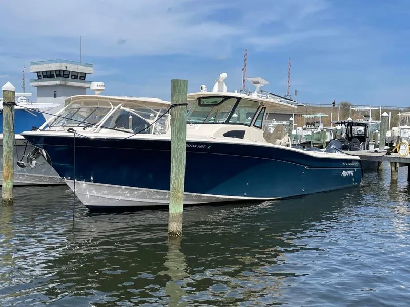 Slide: The Image of 2018 Grady-White Canyon 376 boat docked in a marina under a clear blue sky. - 3
