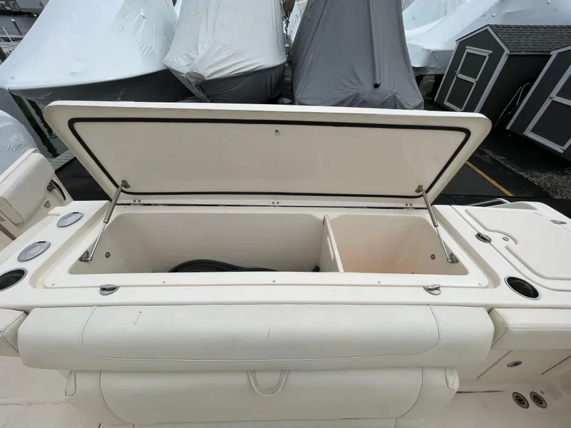 Slide: The Image of 2018 Grady-White Canyon 376 boat with open storage compartment, showcasing spacious interior. - 48