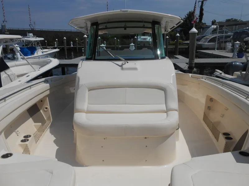 Slide: The Image of 2018 Grady-White Canyon 376 boat docked, featuring spacious seating and sleek design. - 8