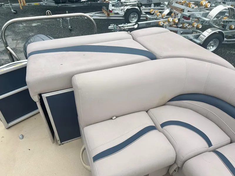 Slide: The Image of 2015 Godfrey Sweetwater 20PE boat interior with beige and blue seating. - 11