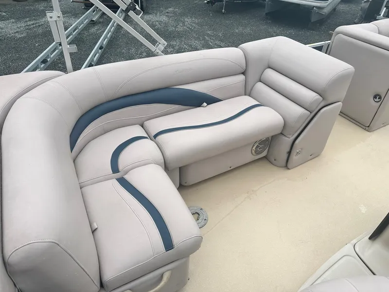 Slide: The Image of 2015 Godfrey Sweetwater 20PE boat interior with beige and blue cushioned seating. - 12
