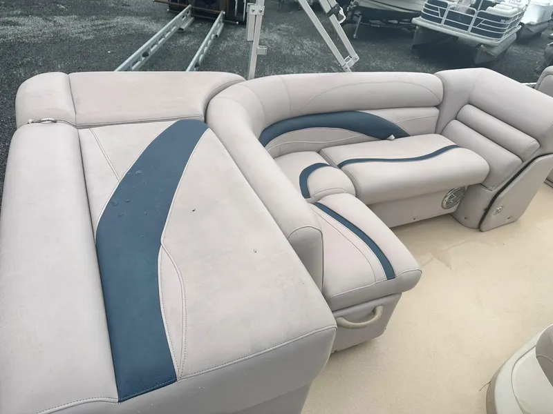Slide: The Image of Luxurious seating on 2015 Godfrey Sweetwater 20PE pontoon boat, featuring beige and blue upholstery. - 13