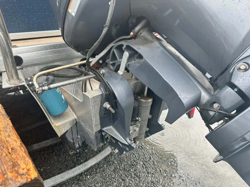 Slide: The Image of Outboard motor of 2015 Godfrey Sweetwater 20PE boat on wet ground. - 15