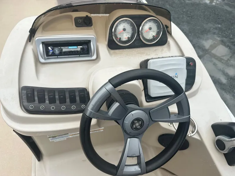 Slide: The Image of Steering console of 2015 Godfrey Sweetwater 20PE boat with gauges and controls. - 4