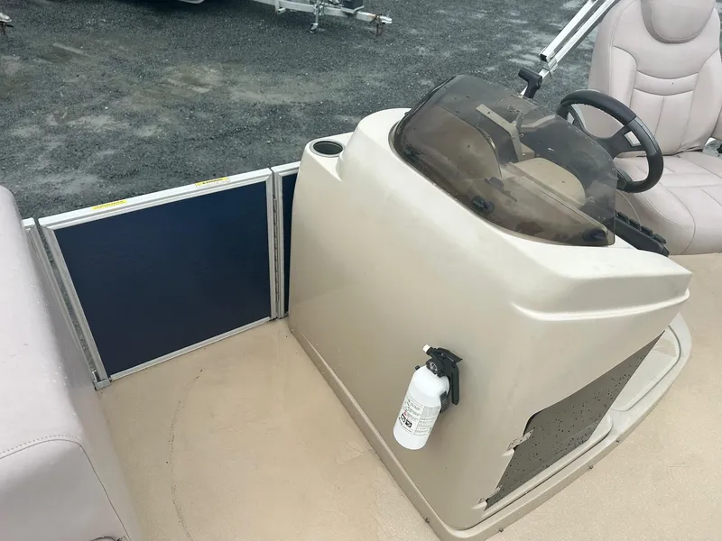 Slide: The Image of 2015 Godfrey Sweetwater 20PE boat console with steering wheel and fire extinguisher. - 5