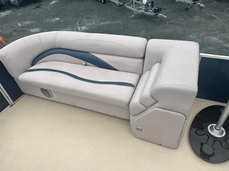 Slide: The Image of 2015 Godfrey Sweetwater 20PE boat interior with beige and blue cushioned seating. - 9
