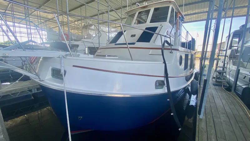 Slide: The Image of 1989 Kadey-Krogen Manatee 36 boat docked in a covered marina. - 10