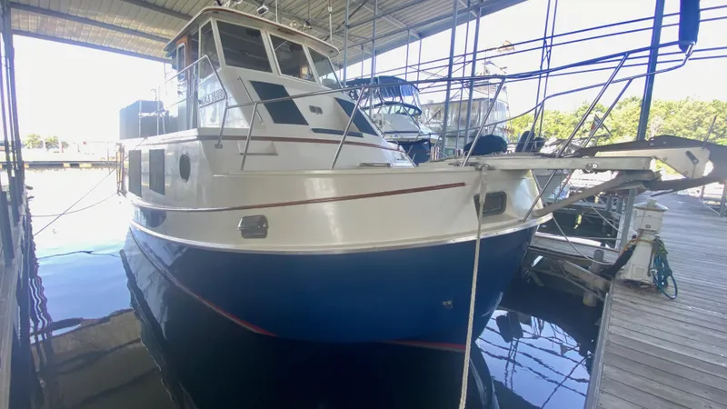 Slide: The Image of 1989 Kadey-Krogen Manatee 36 docked under a covered marina. - 11