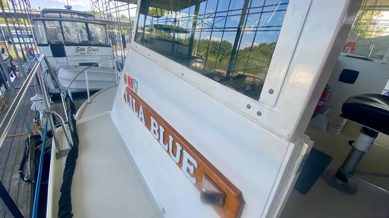 Slide: The Image of 1989 Kadey-Krogen Manatee 36 docked, featuring "Lila Blue" nameplate and marina background. - 12