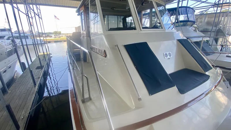 Slide: The Image of 1989 Kadey-Krogen Manatee 36 docked in a marina, showcasing its exterior design. - 13